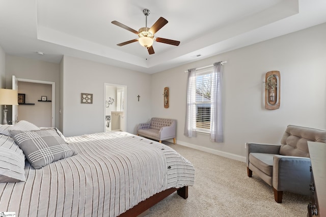 bedroom featuring visible vents, baseboards, light colored carpet, a raised ceiling, and a ceiling fan