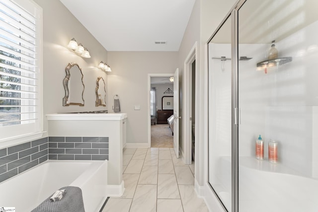 ensuite bathroom with visible vents, a shower stall, a garden tub, marble finish floor, and connected bathroom