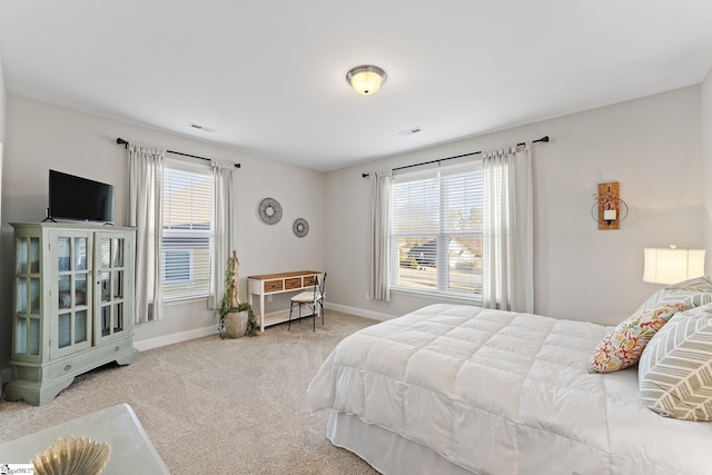 bedroom with multiple windows, carpet flooring, baseboards, and visible vents