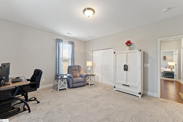 carpeted home office with visible vents and baseboards