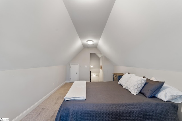 unfurnished bedroom featuring vaulted ceiling, carpet flooring, and baseboards