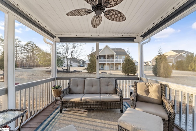 wooden deck featuring a residential view, a ceiling fan, and outdoor lounge area