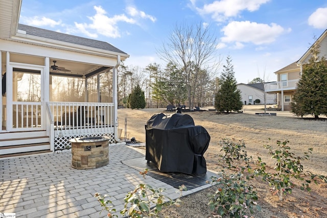 view of patio with a grill and a sunroom