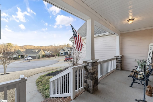 view of patio / terrace with a residential view and a porch