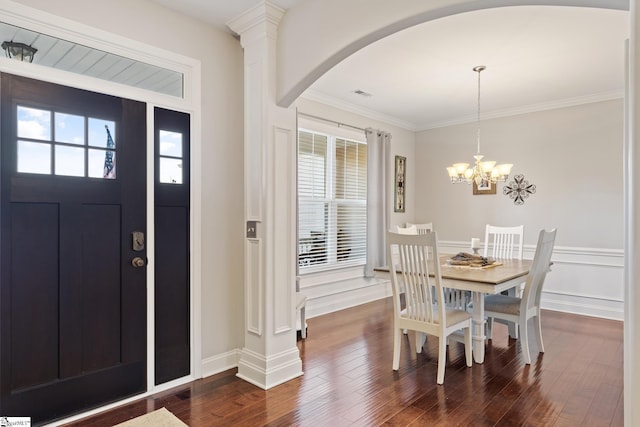 foyer entrance featuring arched walkways, plenty of natural light, visible vents, and dark wood-style flooring