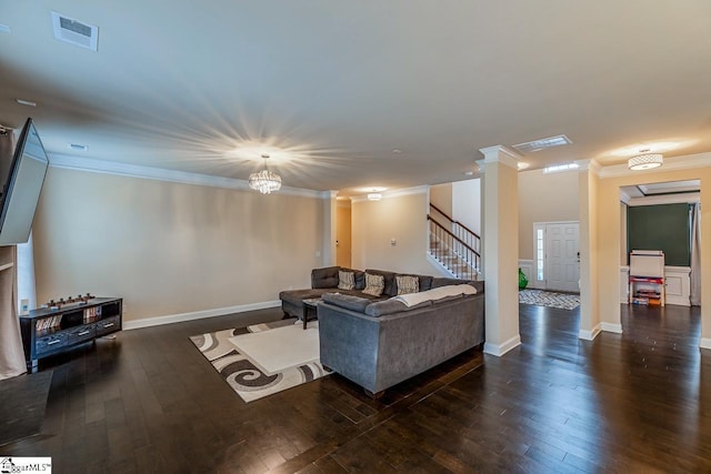 living area featuring hardwood / wood-style floors, crown molding, stairway, and visible vents