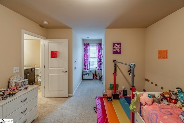 bedroom featuring light carpet and baseboards