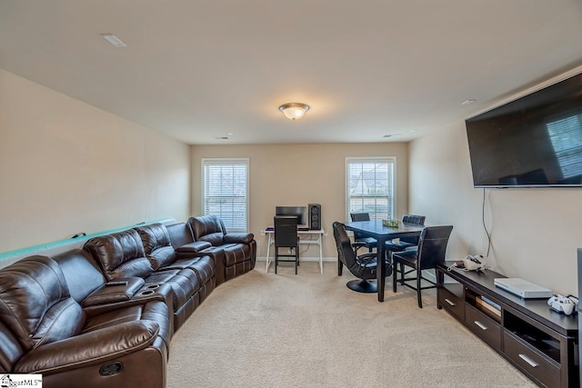 living area featuring baseboards and light colored carpet