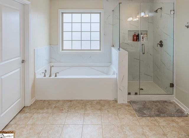 full bathroom with a marble finish shower and a garden tub