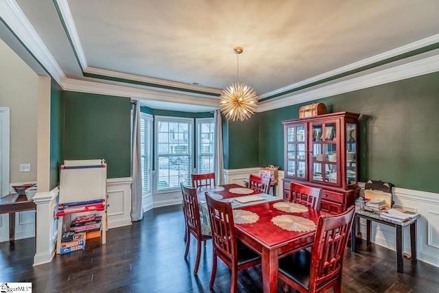 dining space featuring wainscoting, crown molding, an inviting chandelier, and wood finished floors