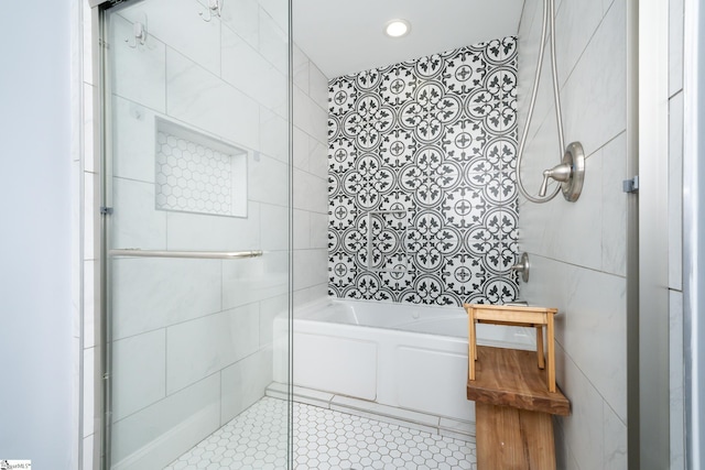 full bath with enclosed tub / shower combo, tile walls, and tile patterned flooring