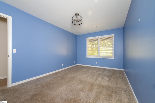 carpeted spare room with baseboards