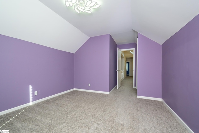 bonus room with lofted ceiling, baseboards, and carpet floors