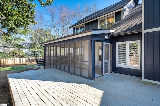 wooden terrace with fence and a sunroom