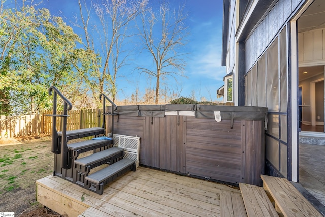 wooden deck with fence and a hot tub