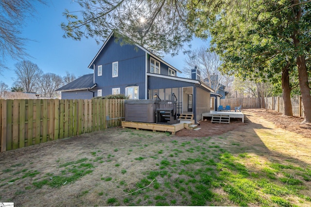 rear view of house featuring a fenced backyard and a deck