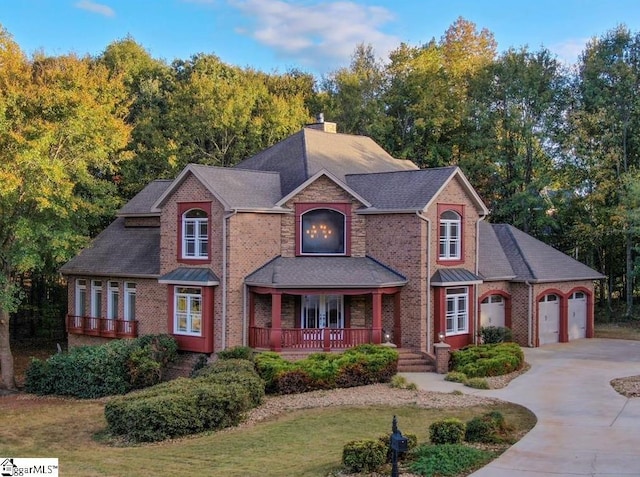 view of front of house featuring covered porch, a chimney, concrete driveway, a garage, and brick siding