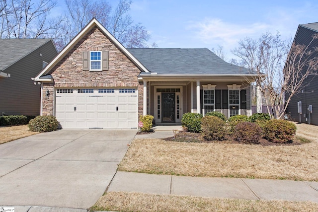 view of front of home featuring stone siding, concrete driveway, and a garage