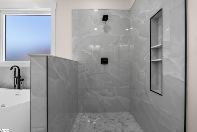 bathroom featuring a marble finish shower