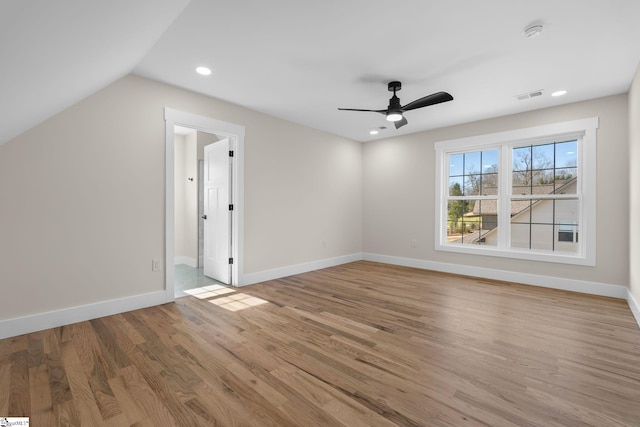 interior space with visible vents, baseboards, lofted ceiling, and wood finished floors