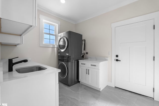 clothes washing area with marble finish floor, ornamental molding, a sink, stacked washing maching and dryer, and cabinet space