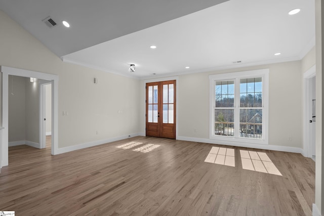 empty room featuring baseboards, ornamental molding, and light wood finished floors