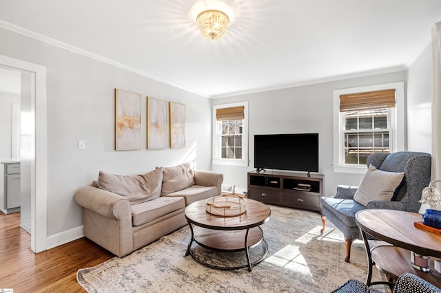 living area with light wood-type flooring, baseboards, and crown molding