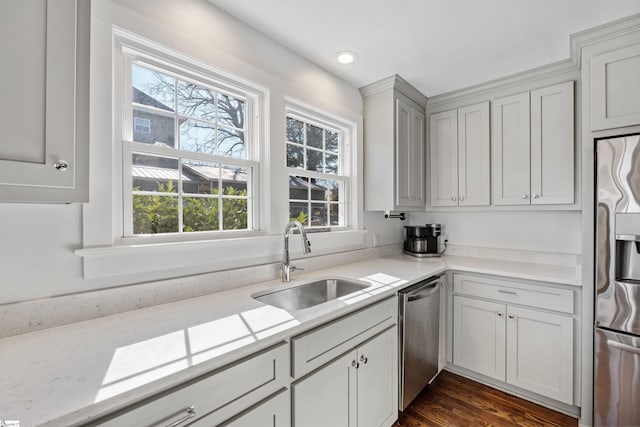 kitchen featuring light countertops, a wealth of natural light, appliances with stainless steel finishes, and a sink