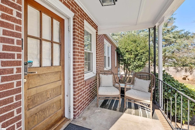 exterior space featuring covered porch and brick siding