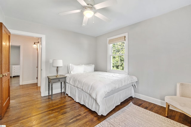 bedroom with a ceiling fan, baseboards, and wood finished floors