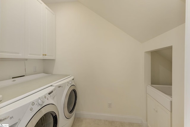 laundry room featuring cabinet space, baseboards, and washing machine and clothes dryer