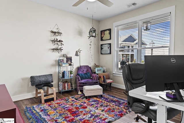 office area featuring visible vents, baseboards, wood finished floors, and a ceiling fan