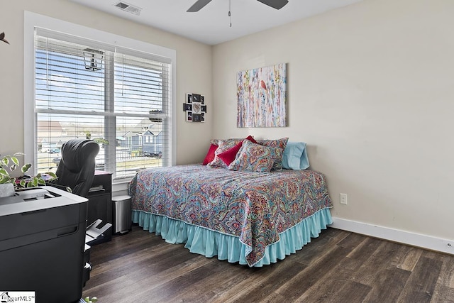 bedroom with multiple windows, dark wood-style floors, and visible vents