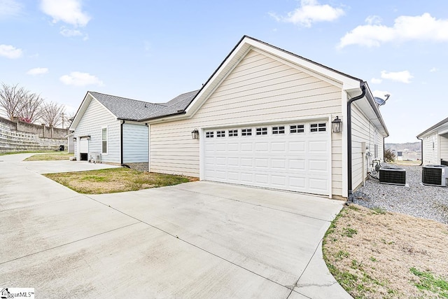 exterior space with central air condition unit and driveway