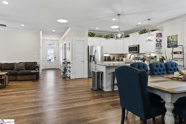 dining area featuring recessed lighting, dark wood-type flooring, and crown molding