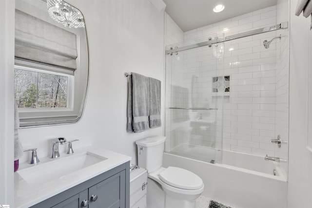 bathroom featuring vanity, toilet, and combined bath / shower with glass door