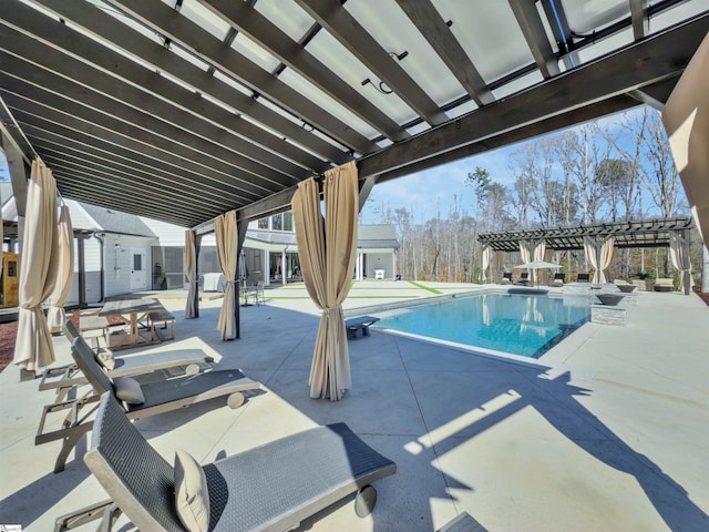 pool featuring a patio area, a storage shed, a pergola, and an outbuilding