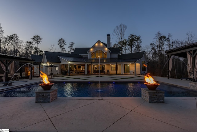 outdoor pool featuring a patio and an outdoor fire pit