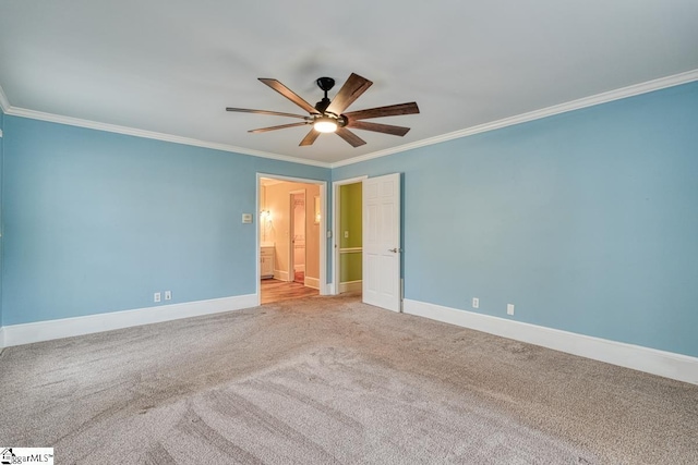 spare room with carpet flooring, baseboards, a ceiling fan, and crown molding