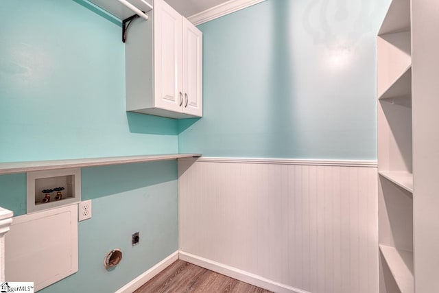 laundry room with hookup for a washing machine, wood finished floors, a wainscoted wall, cabinet space, and electric dryer hookup