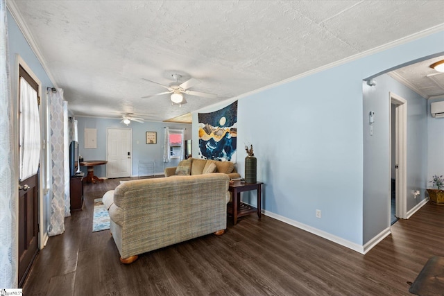 living room with a wealth of natural light, an AC wall unit, crown molding, and wood finished floors