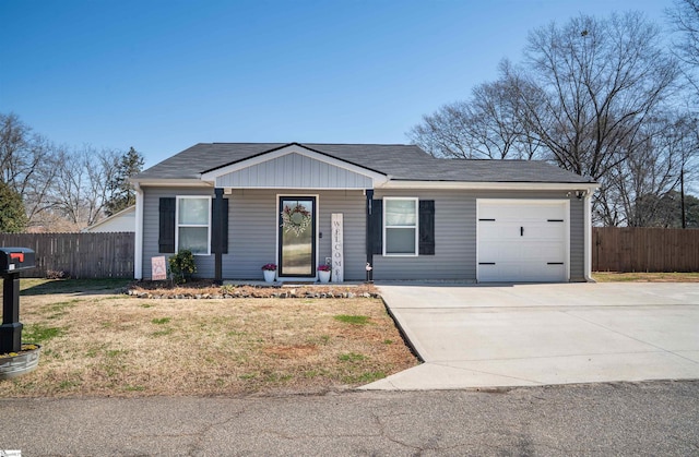 ranch-style home with a garage, roof with shingles, driveway, and fence