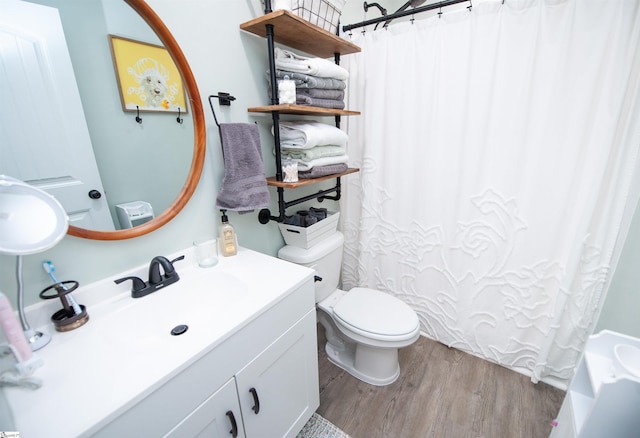 full bath featuring vanity, toilet, and wood finished floors