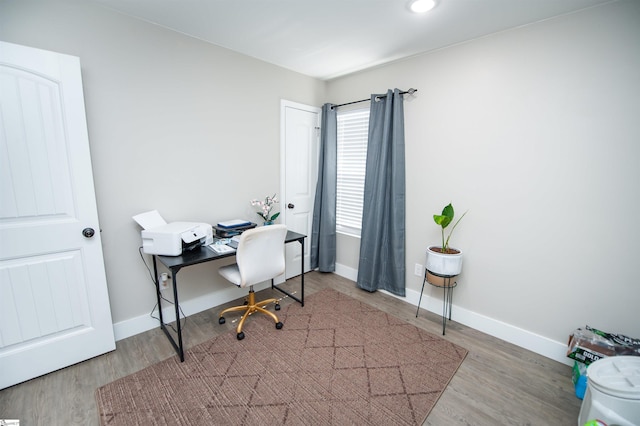 office space featuring baseboards and wood finished floors