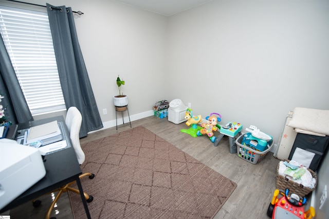 office area with baseboards and wood finished floors