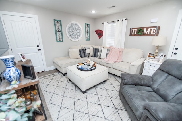 living area featuring visible vents, recessed lighting, baseboards, and light wood-style floors