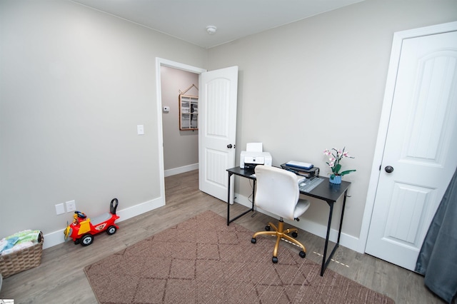 office space featuring wood finished floors and baseboards