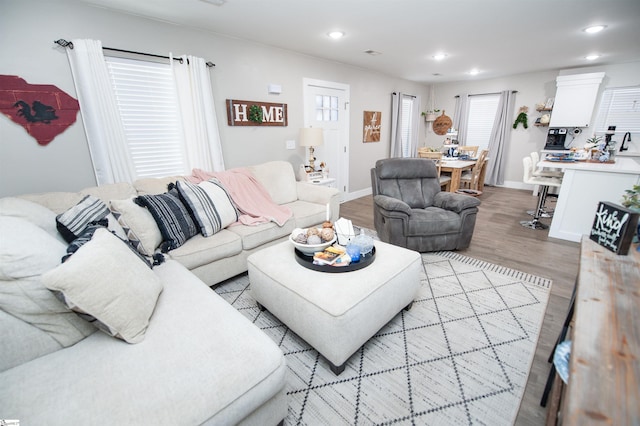 living room with recessed lighting, baseboards, and wood finished floors