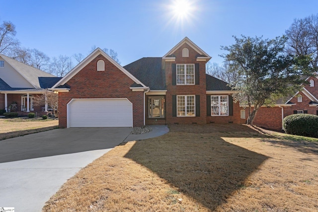 traditional-style house with brick siding, a front lawn, a garage, crawl space, and driveway