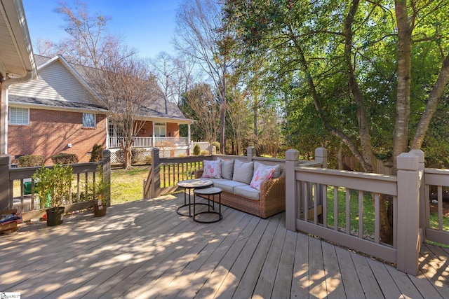 wooden terrace with an outdoor hangout area